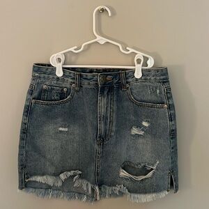 medium wash ripped jeans skirt with frayed bottom